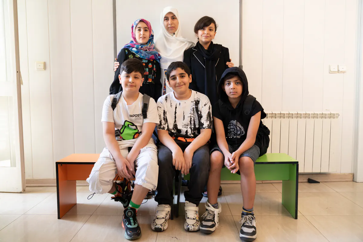 Three Orange team members with three students.